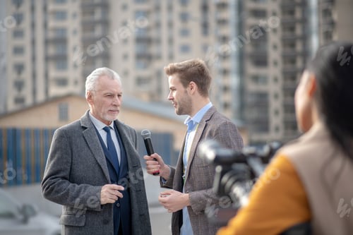 Preview: Reporters from television looking busy talking to a famous businessman