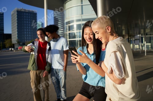 Preview: Group of friends using their phones. Young people and social media concept.