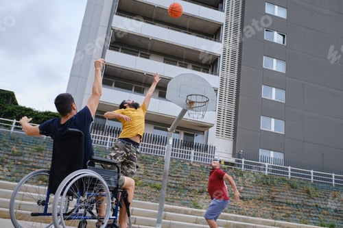 Preview: disabled sport man in wheelchair in action while playing basketball at a basketball court