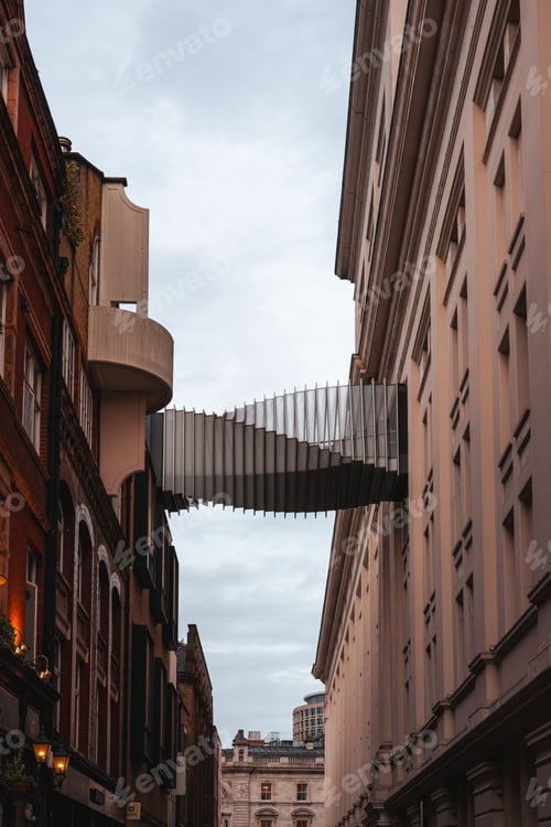 Preview: Modern bridge between historic London buildings.