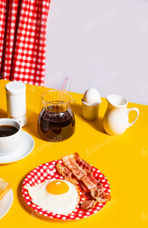 Preview: Fried egg with roasted bacon, black coffee, toasts on yellow background. Retro American breakfast