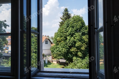 Preview: View of the courtyard from the open windows of the house on a summer day