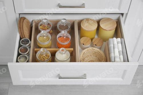 Preview: Open drawer with different jars indoors. Order in kitchen