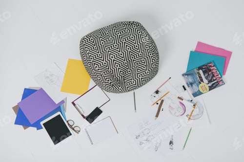 Preview: Fashion illustrations and digital devises on floor with cushion