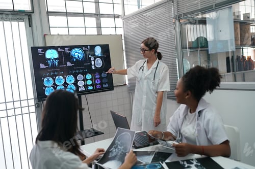 Preview: Group of doctors looking at X-ray on medical conference, discussing issues