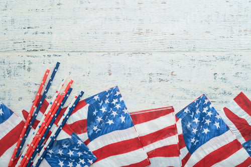 Preview: 4th of July background. US flag paper napkin and picnic cocktail straws on old white table backgroun