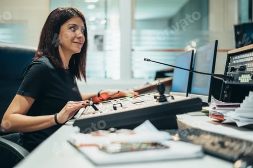 Preview: Young beautiful woman working in a broadcast control room on a tv station