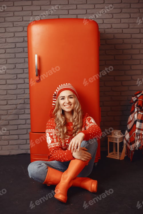 Preview: Beautiful girl at home near red refrigerator