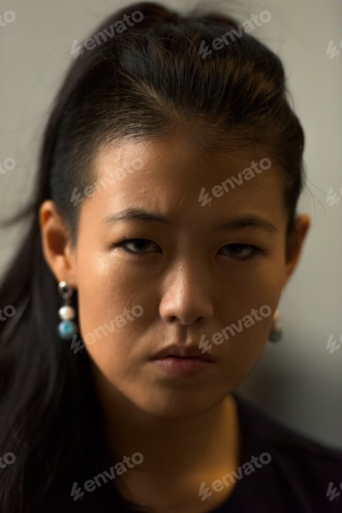 Preview: Close-up portrait of beautiful rebel Asian woman face outdoors
