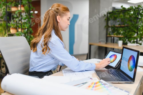 Preview: Woman designer creating color palette on digital tablet