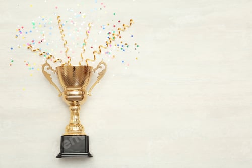 Preview: Golden trophy cup and streamers on wooden background, top view with space for text