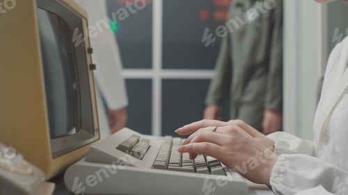 Preview: Woman working with an old computer