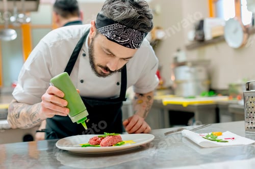 Preview: Chef meticulously garnishing a dish in a professional kitchen
