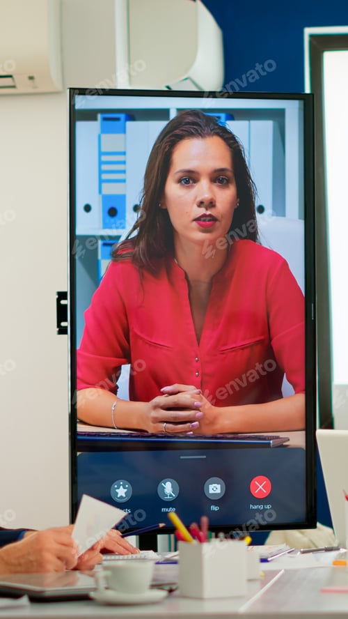 Preview: Diverse executive team meeting at conference video call looking at huge display