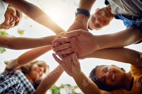 Preview: Cropped shot of a happy family joining hands together in unity at the park