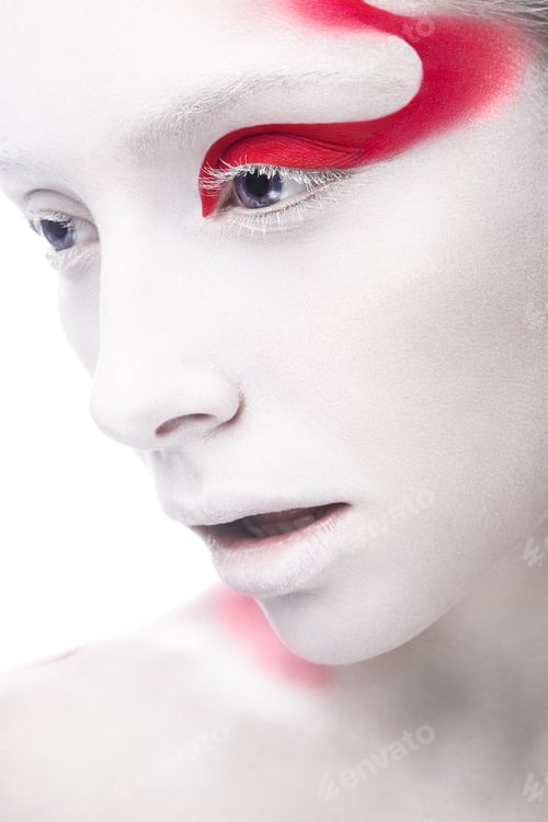 Preview: Art fashion girl with white skin and red paint on the face. Creative art beauty.