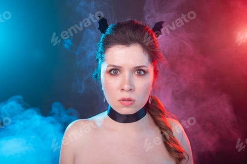 Preview: Halloween, holidays and carnival concept - portrait of woman in gothic style is looking very serious