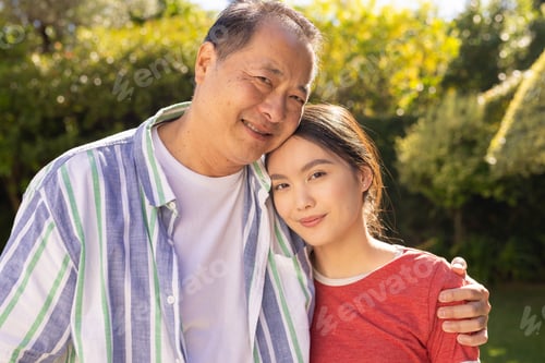 Preview: Embracing outdoors, smiling asian father and daughter enjoying quality family time together