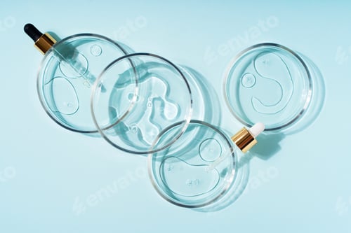 Preview: Cosmetic beauty concept with bottle serum, drops and petri dish on blue background