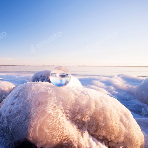 Preview: Glass sphere on frozen rock formations