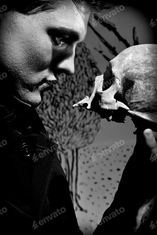 Preview: A young man dressed in black with a skull in his hands. Black and white. Artistic background created