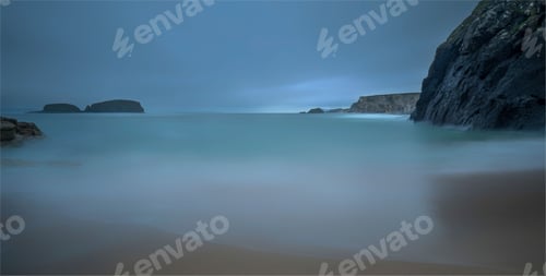 Preview: Breathtaking view of the calm see with rock formation in the background, long exposure