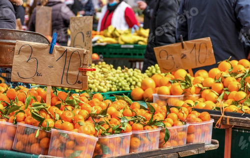 Preview: Vibrant citrus fruits for sale on market stall.