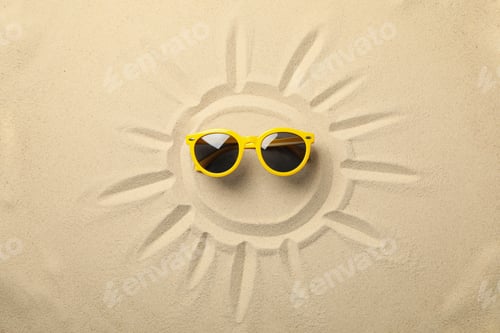 Preview: Painted sun and yellow sunglasses on sea sand