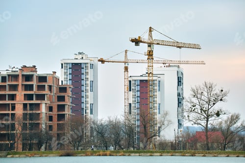 Preview: Tower cranes at high residential apartment buildings construction site. Real estate development