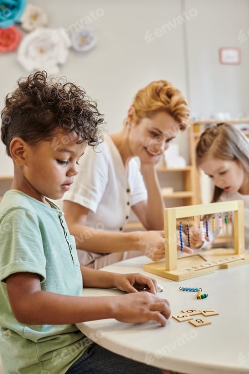 Preview: african american boy counting and using tiles, montessori concept, teacher and girl playing game