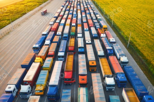 Preview: Aerial view of colorful trucks in terminal at sunset in summer