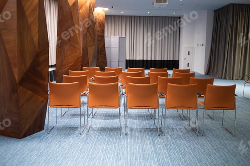 Preview: empty chairs and table in modern conference hall