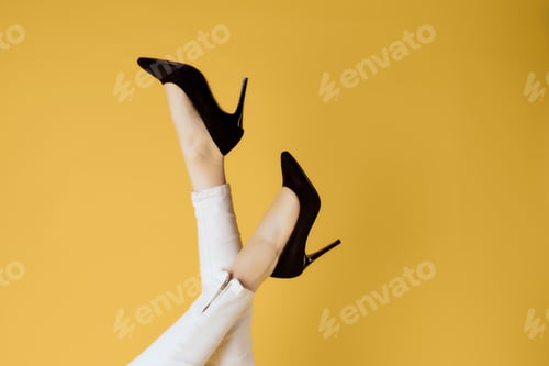 Preview: womens shoes upside down posing cropped view yellow background