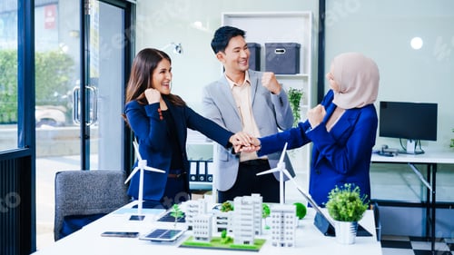 Preview: Three business people gather at a desk, unit with joined hands sustainable solutions for a cleaner