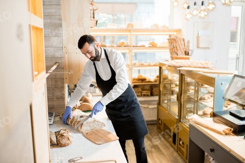 Preview: Seller cutting a bread