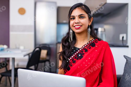 Preview: business women in sari laptop working in living room at home