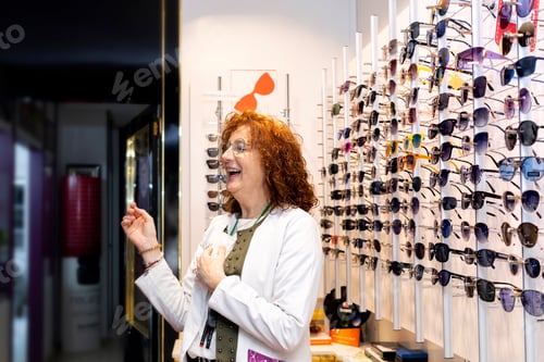 Preview: Row of sunglasses at an opticians. Eyeglasses shop. Stand with glasses in the store of optics