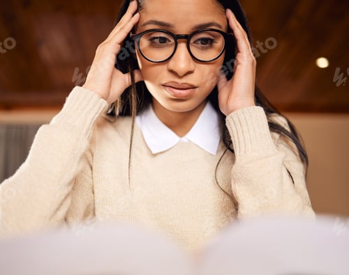 Preview: Shot of a college student looking stressed while studying at home
