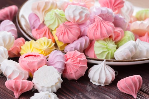 Preview: Colorful sweet meringue cookies assortment on wooden table