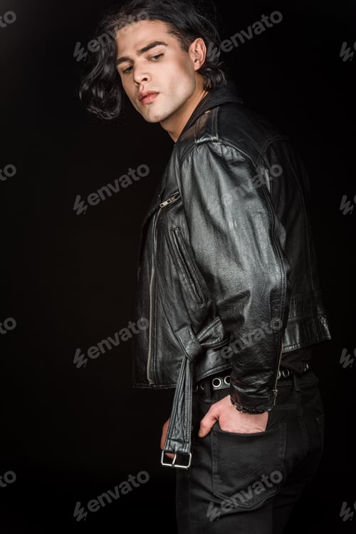 Preview: serious man standing with hand in pocket isolated on black