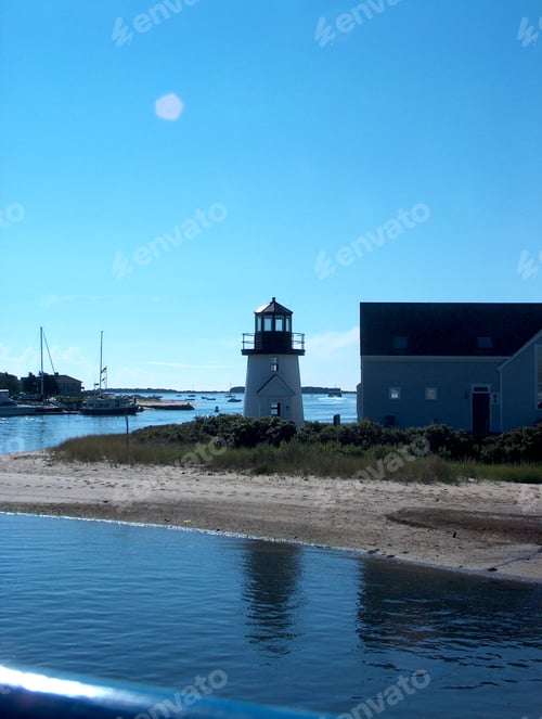 Preview: Lighthouse on sandy island at marina