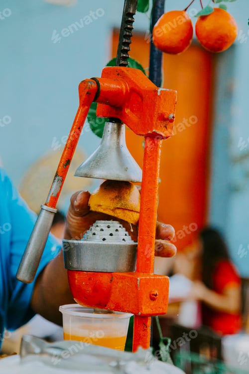 Preview: Man squeezing orange to make orange juice