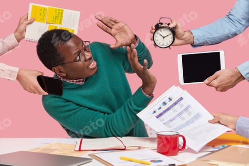 Preview: Stressful dissatisfied dark skinned guy makes refusal sign, raises palms over alarm clock, touchpad