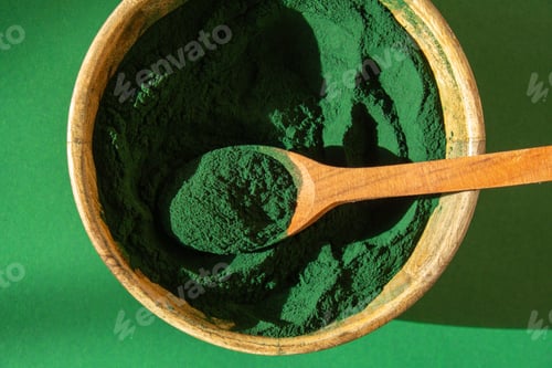 Preview: Blue-green algae Chlorella and spirulina powder in bamboo eco bowl. Super powder in spoon. Detox