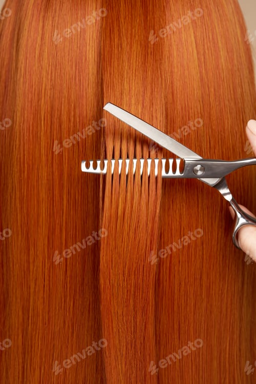 Preview: Hairdresser cuts long red hair with scissors