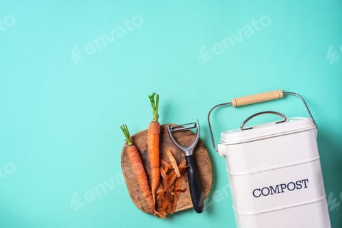 Preview: Top view of kitchen food waste collected in recycling compost pot. Peeled vegetables on chopping