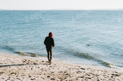 Preview: Woman Strolls Along Sandy Beach Enjoying Ocean View