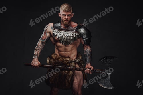 Preview: Brutal tattooed warrior wearing light armour and fur holding two-handed axe in dark studio