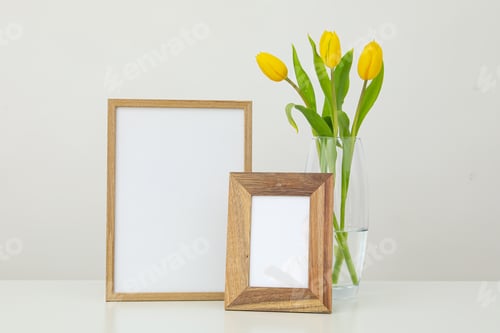 Preview: Frames of different sizes on the table near a vase of flowers