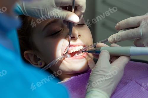 Preview: Pediatric dentists performing dental procedure on young girl